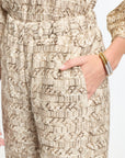 Close-up of a textured beige dress with a patterned design.