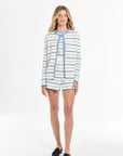 Woman wearing a striped shirt and shorts on a white background