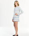Female model styled in a striped long-sleeve shirt and coordinating shorts on a clean white background.