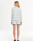 Woman showcasing a striped long-sleeve top and shorts set, photographed on a crisp white studio background.
