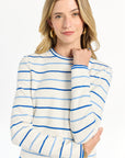 Woman wearing a striped long-sleeve top paired with matching shorts against a white backdrop.