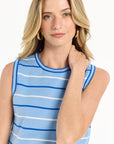 Woman wearing a light blue and white striped sleeveless top on a white background