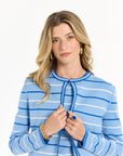 Woman wearing a blue and white striped sweater on a white background