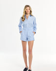 Woman wearing a light blue outfit on a white background
