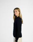 Woman wearing a black silk cardigan on a white background