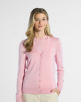 Woman wearing a pink silk cardigan on a white background