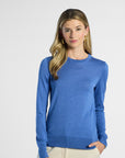 Woman wearing a blue sweater on a white background