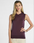 Woman wearing a purple sleeveless silk top against a white background