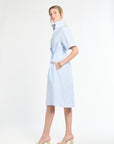 Woman wearing a light blue dress on a white background