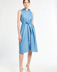 Woman modeling a sleeveless blue dress against a white background