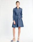 Woman wearing a blue dress on a white background