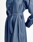 Blue denim dress with a belt on a white background