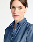 Woman wearing a blue shirt against a white background