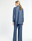 Woman wearing a blue outfit on a white background