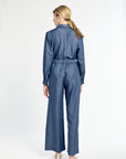Woman wearing a blue jumpsuit on a white background