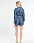 Woman wearing a blue denim romper on a white background