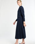 Woman wearing a navy blue outfit on a white background