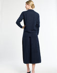 Woman wearing a navy blue suit on a white background