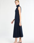 Woman wearing a navy sleeveless dress with a white background