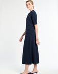 Woman wearing a navy blue dress on a white background