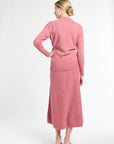 Woman wearing a pink outfit on a white background