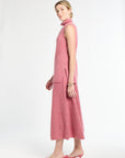 Woman wearing a pink sleeveless dress on a white background
