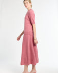 Woman wearing a pink outfit on a white background