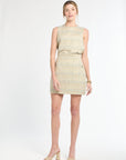 Woman wearing a sleeveless tweed top paired with a tweed mini skirt on a white background