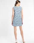 Back of woman wearing a blue tweed sleeveless dress on a white background