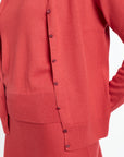 Red cardigan with buttons on a white background