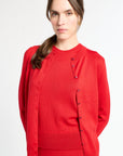 Woman wearing a red outfit with buttons on a white background