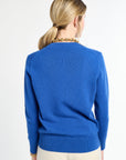 Person wearing a blue sweater on a white background