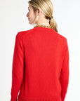 Woman wearing a red sweater on a white background