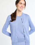 Woman wearing a light blue cardigan on a white background