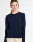 Woman wearing a navy blue sweater on a white background