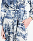 Blue and white floral patterned dress with a tie waist on a white background