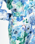 Close-up of a floral shirt and pants with blue and green flowers on a white background