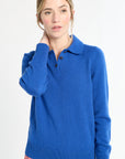 Woman wearing a blue sweater with a collar on a white background