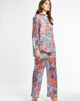 Woman wearing a colorful floral outfit on a white background