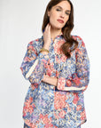 Woman wearing a colorful floral outfit on a white background