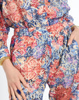 Multicolored floral patterned outfit with a belt on a white background