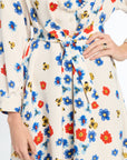 Floral dress with colorful flowers and bees on a white background