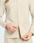 Beige suit jacket worn by a person on a white background