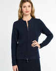 Woman wearing a navy blue jacket on a white background