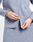 Woman wearing a light blue cardigan on a white background