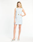 Woman wearing a light blue checkered dress on a white background