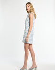 Woman wearing a sleeveless checkered dress on a white background