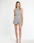 Woman wearing a patterned romper on a white background