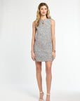 Woman wearing a patterned dress on a white background