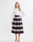 Woman wearing a white shirt and plaid skirt on a white background